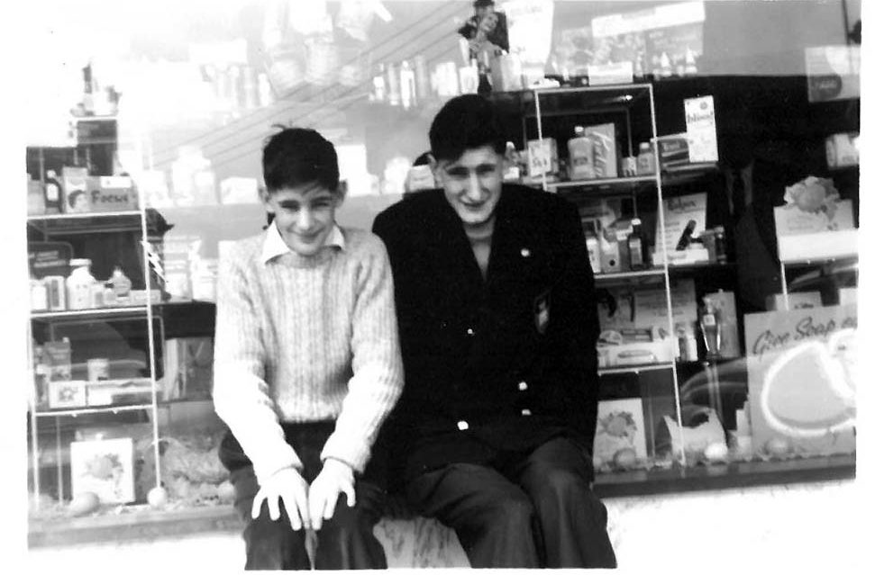 David with his older brother outside their father's pharmacy in the 1950s