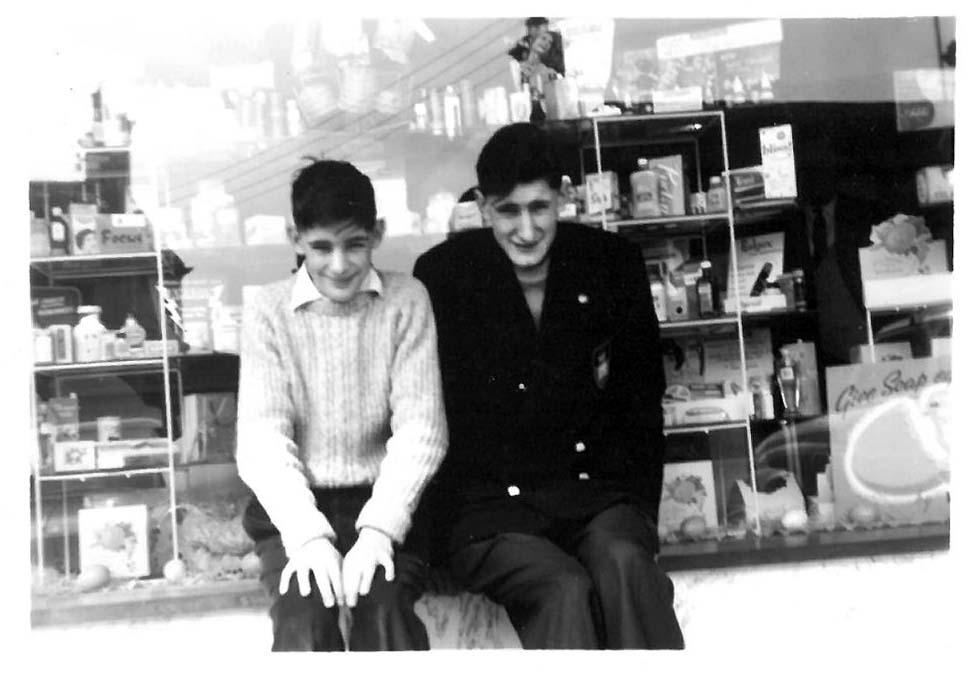David with his older brother outside their father's pharmacy in the 1950s