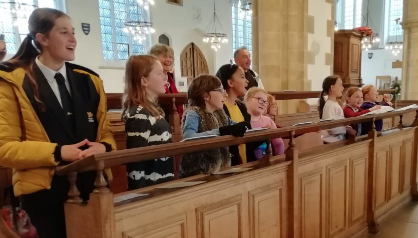decani and volunteers singing