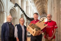 The Rt Revd Graham Usher, Bishop of Norwich, will deliver some of the 7000 pledges to protect the planet to COP26, inspired by Dippy the dinosaur's visit to Norwich Cathedral. Photograph: Norwich Cathedral/Bill Smith
