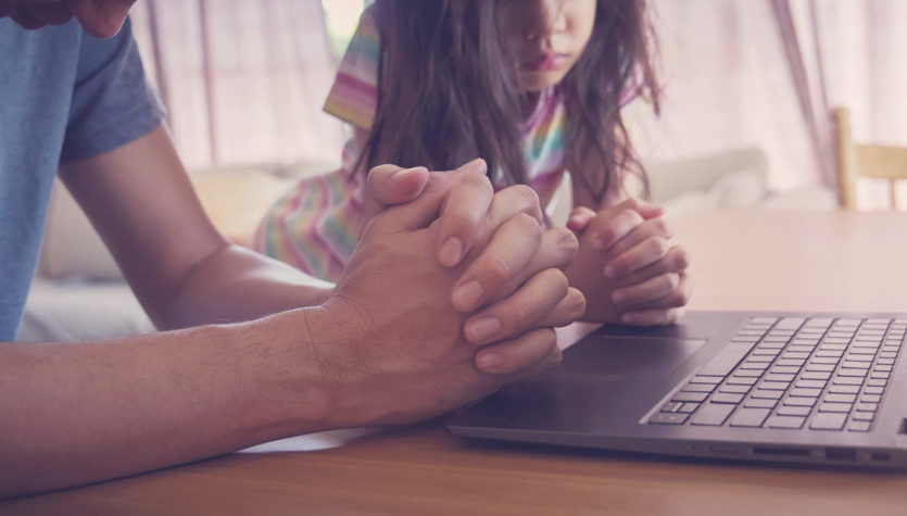 praying hands, family praying with laptop, and parent and kid worship online together at home, streaming online church service, social distancing concept