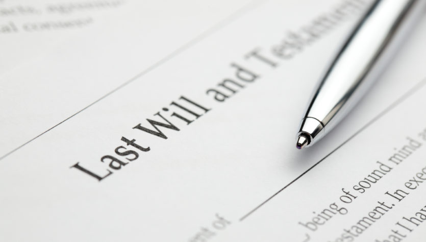 A blank last will and testament form with a pen laying over it.