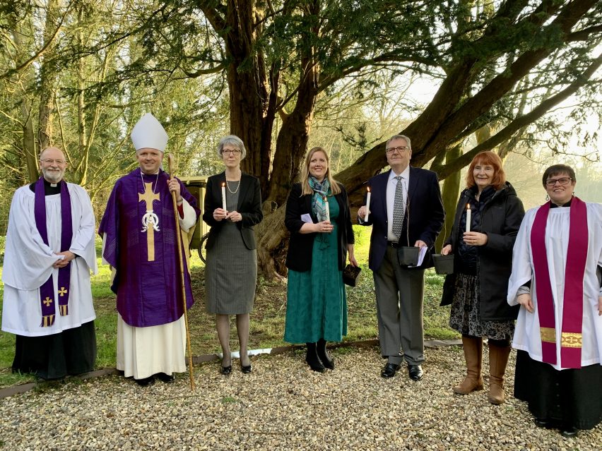 Confirmands with their candles and hazel saplings