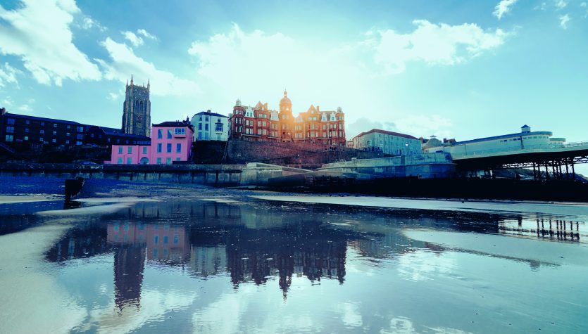 Buildings By River Against Sky In City