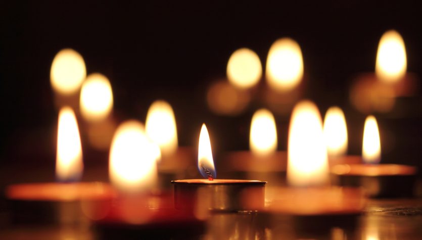 Candles light select focus, black background.