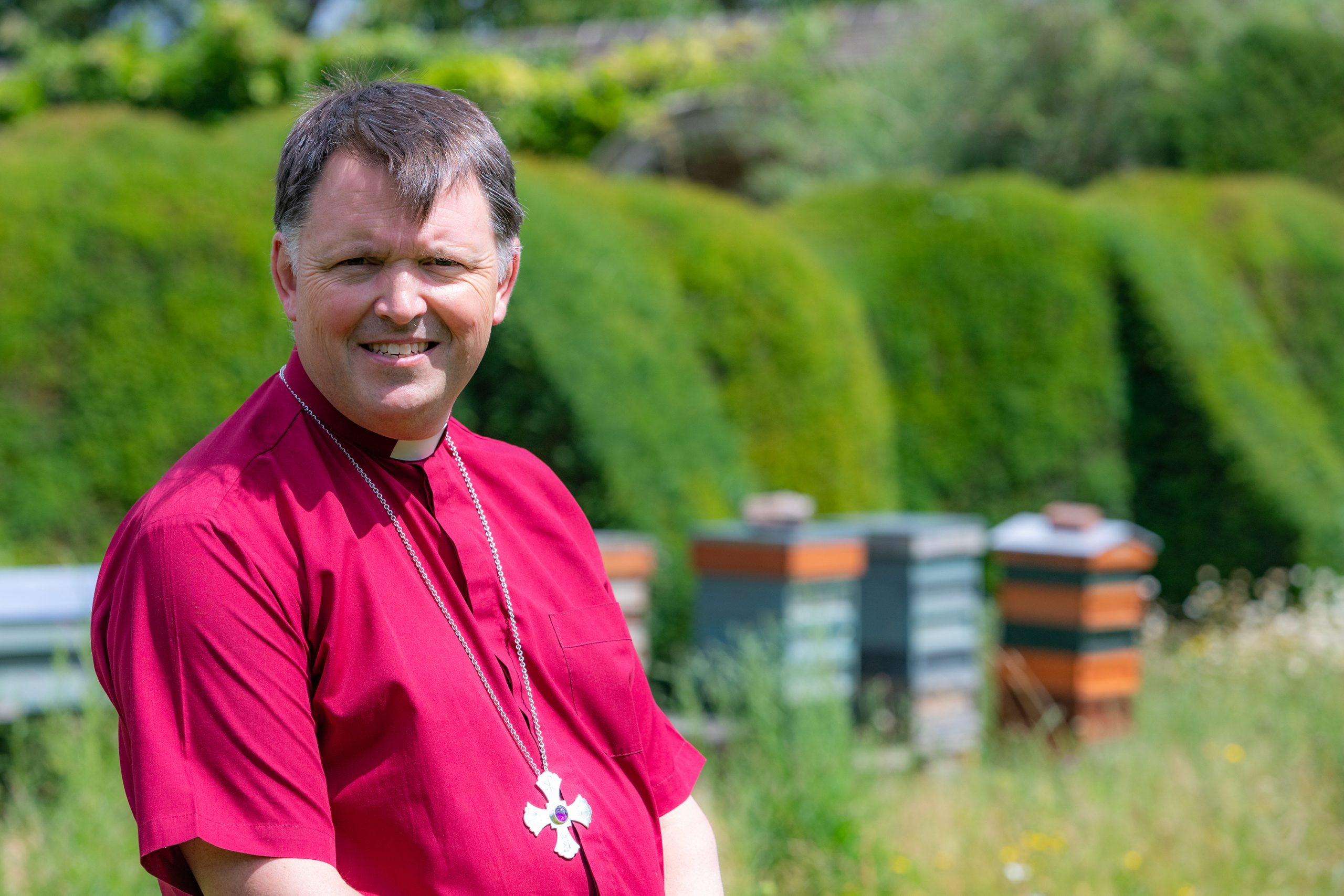 Bishop Graham with bee hives close-up