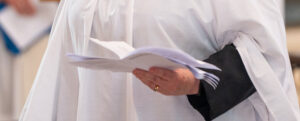Clergy with order of service