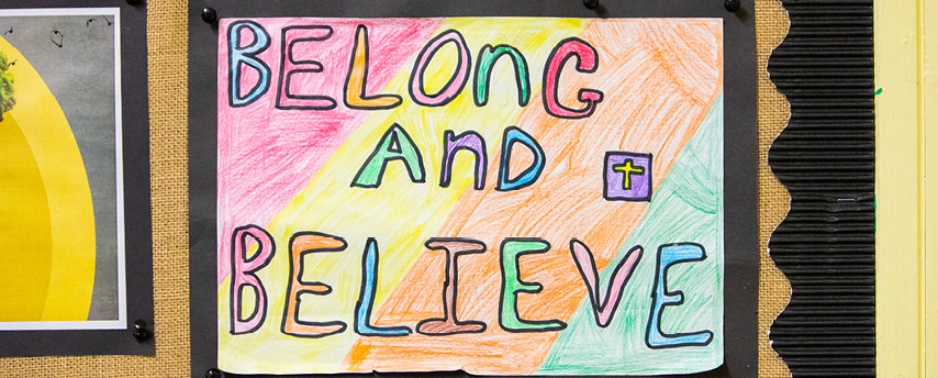 Belong and believe poster on classroom wall