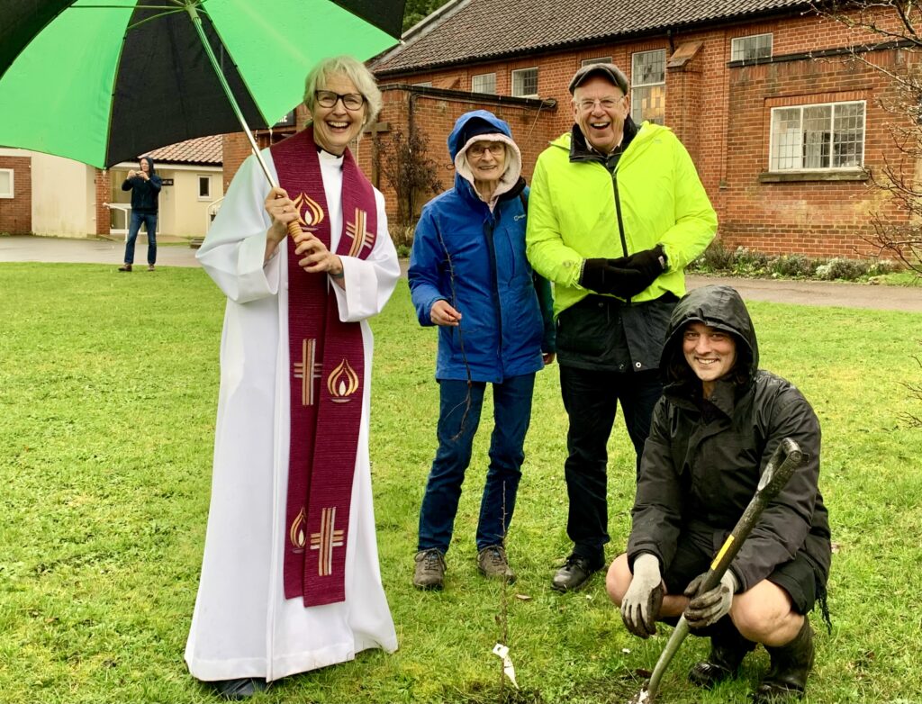 Crossroads Earlham congregation outside planting a tree for #ShowTheLove 