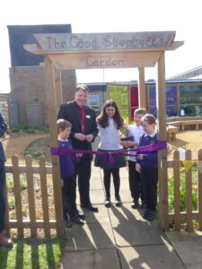 Bishop Graham - Opening the Garden with the help from monitors William, Jacob, Amani and Heath.