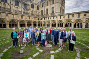 A group of people in the grounds of Norwich Cathedral