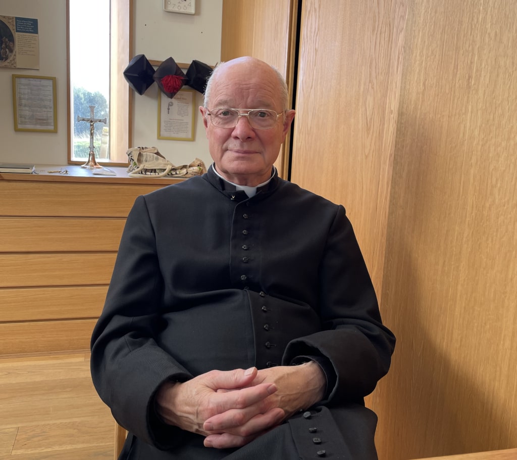 A picture of Christopher Davies sitting down in an office.